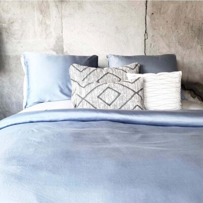 slaapkamer met houten muur en blauw dekbedovertrek