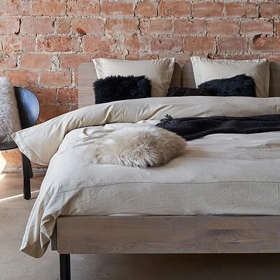 bed met luxe dekbedovertrek zand